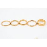 Five 22ct gold wedding bands, various sizes.