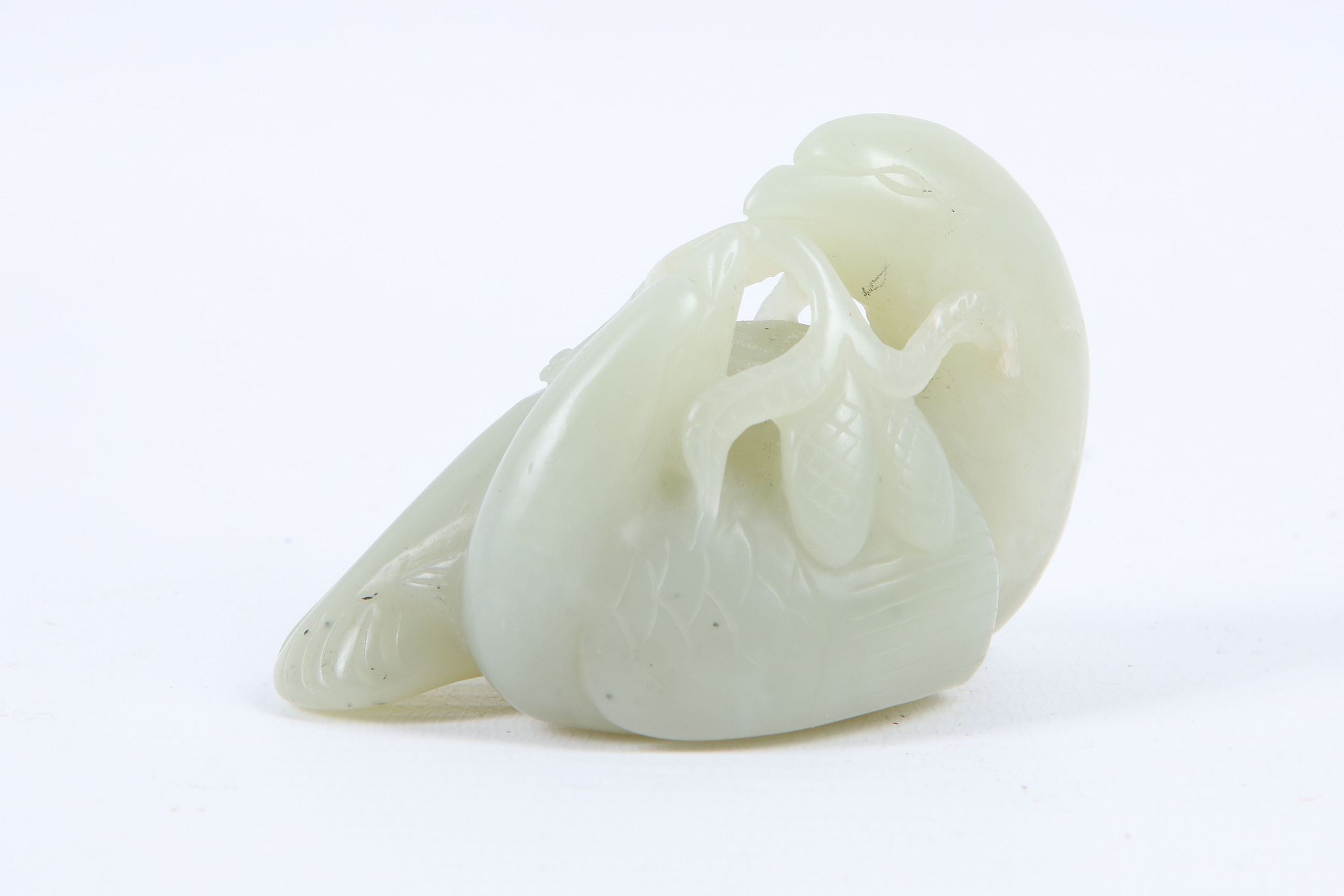 A Chinese jade carving of two birds sharing fruit, 7cm.