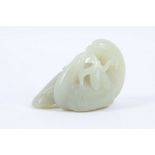 A Chinese jade carving of two birds sharing fruit, 7cm.