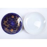 A 19th Century dark blue glazed saucer, enamelled with Chinese dragon and another Chinese 20th