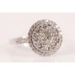 A diamond and 18ct white gold cluster ring, set throughout with brilliant cut diamonds. Total