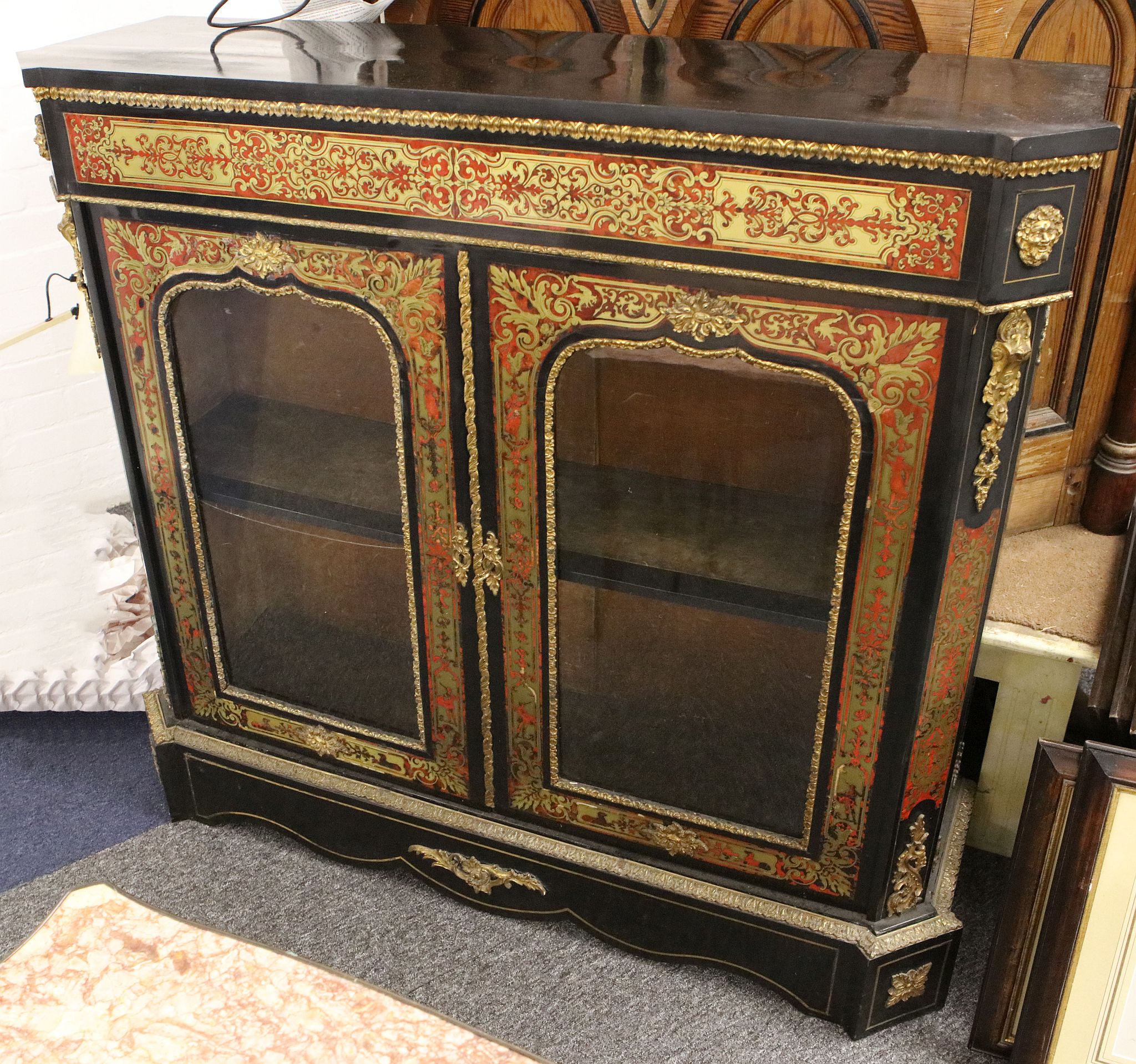 An English red tortoiseshell and brass boulework credenza c.1860, with typical gilt