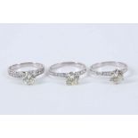 A group of three brilliant cut diamond single stone rings, each central diamond weighing approx. 1.