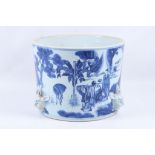 An early 20th Century Chinese blue and white jardiniere, printed with figures in landscape forest