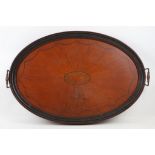 A large Edwardian oval shaped mahogany twin handled serving tray.