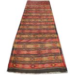 Four assorted rugs to include a Kurdish kilim runner, two Pakistan runners and a Turkish