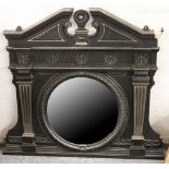 A late Victorian cast iron overmantle, having decorative pediment to top and containing a circular