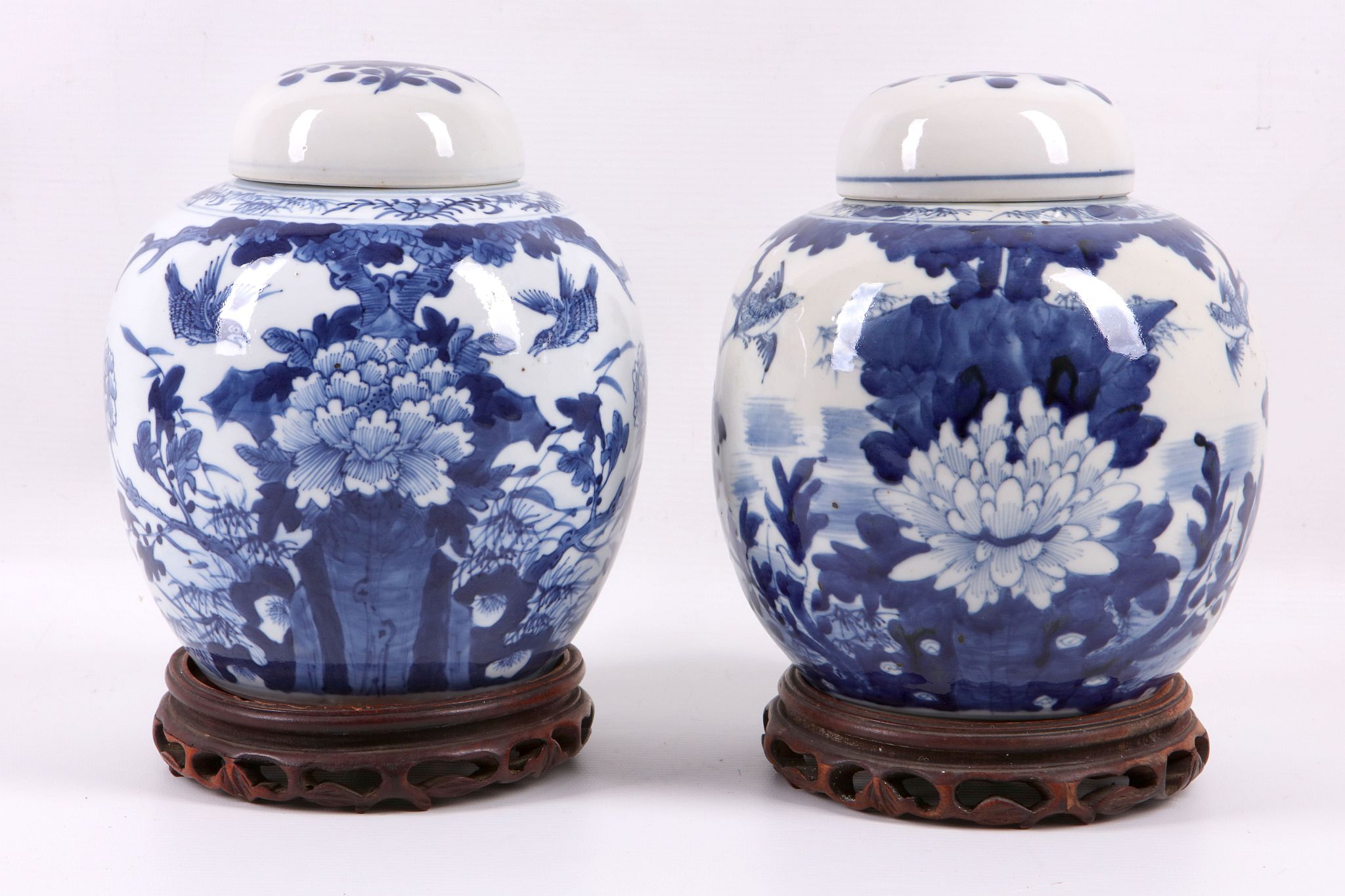 A pair of Chinese 19th Century blue and white ginger jars and covers, decorated all round with birds