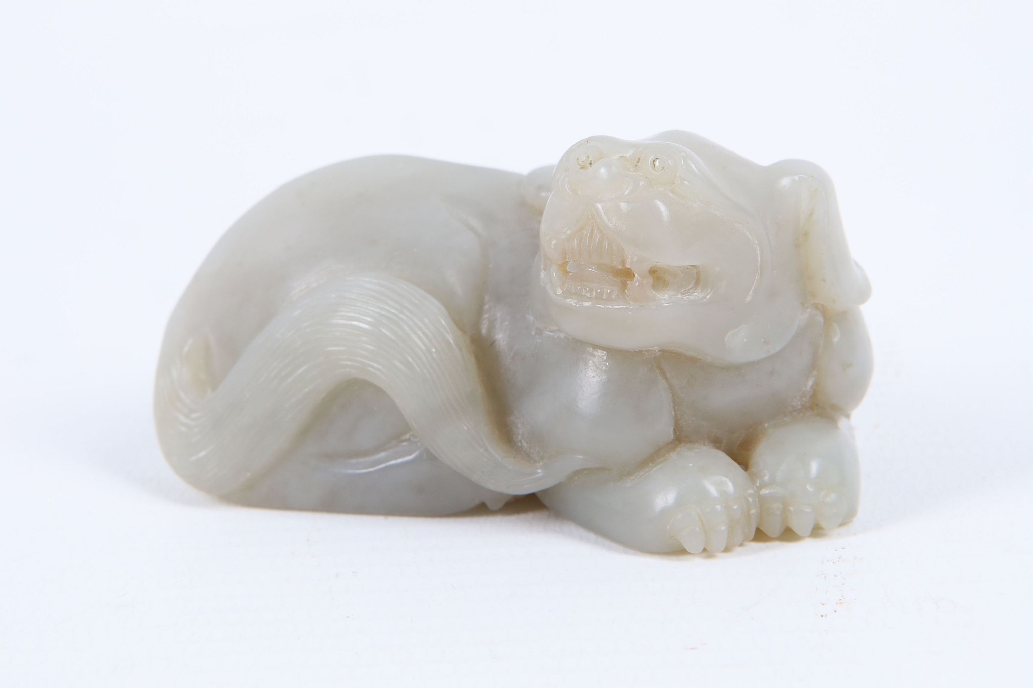 A Chinese mutton fat jade carving of a recumbent dog of Fo, 6.5cm.