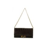 LOEWE BROWN CROCODILE CLUTCH BAG, 1970s, with gilt metal turn lock and multi chain strap, 31cm wide,