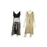 TWO 1930s FLAPPER DRESSES, one black silk and sheer black lace with stitched flower head and