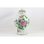 A late 19th Century Chinese vase and cover, painted to the side with flower heads and on the other