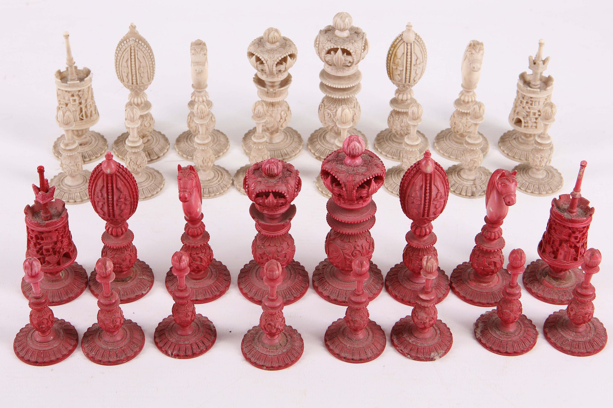 An antique Canton ivory chess set, finely carved and half red stained.