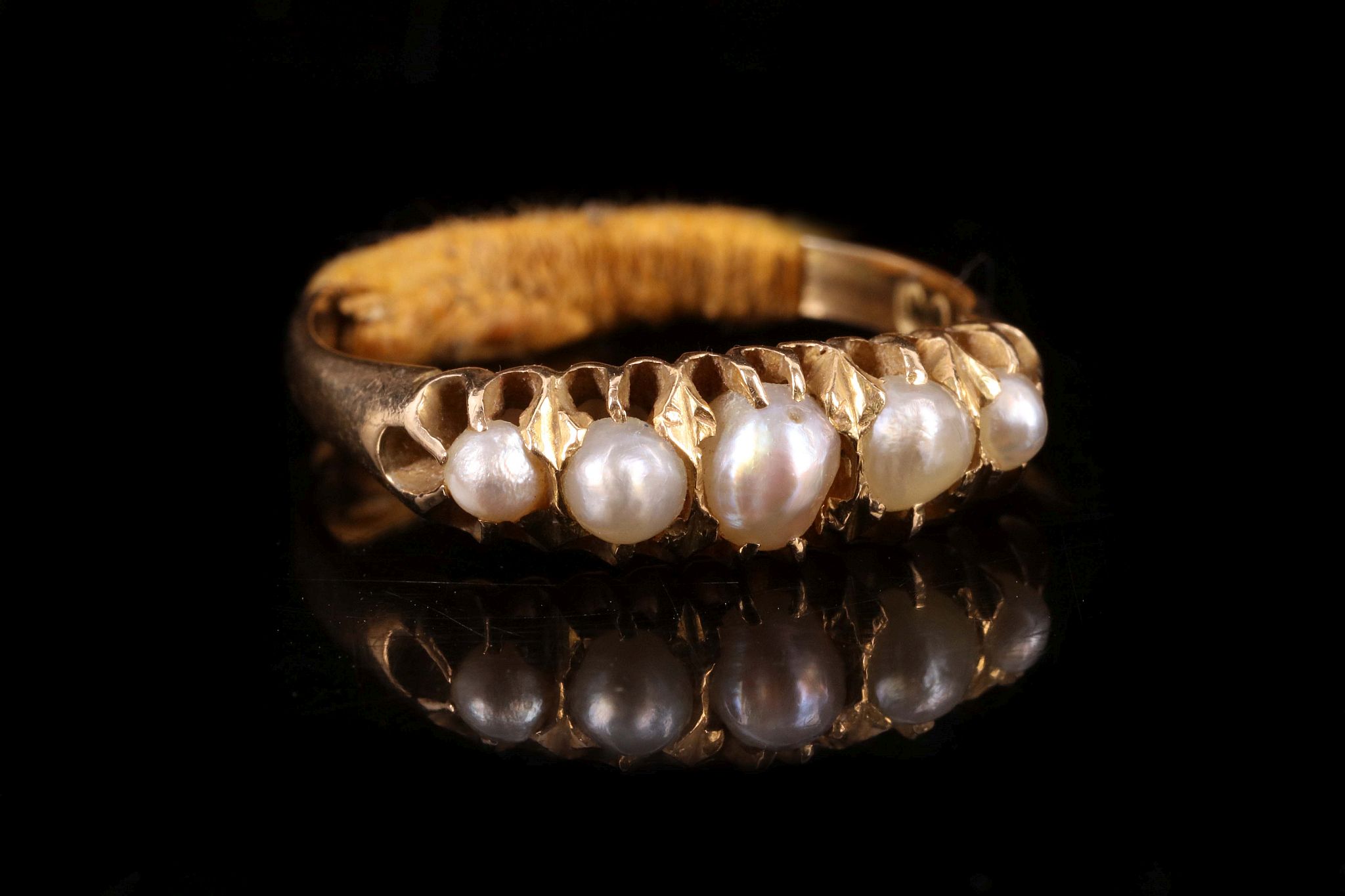 An antique 18ct yellow gold and graduated pearl five stone ring, c.1900.