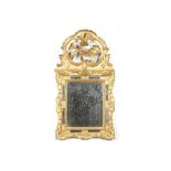 A 19TH CENTURY FRENCH ROCOCO STYLE GILTWOOD WALL MIRROR the foliate frame with mirrored slip and