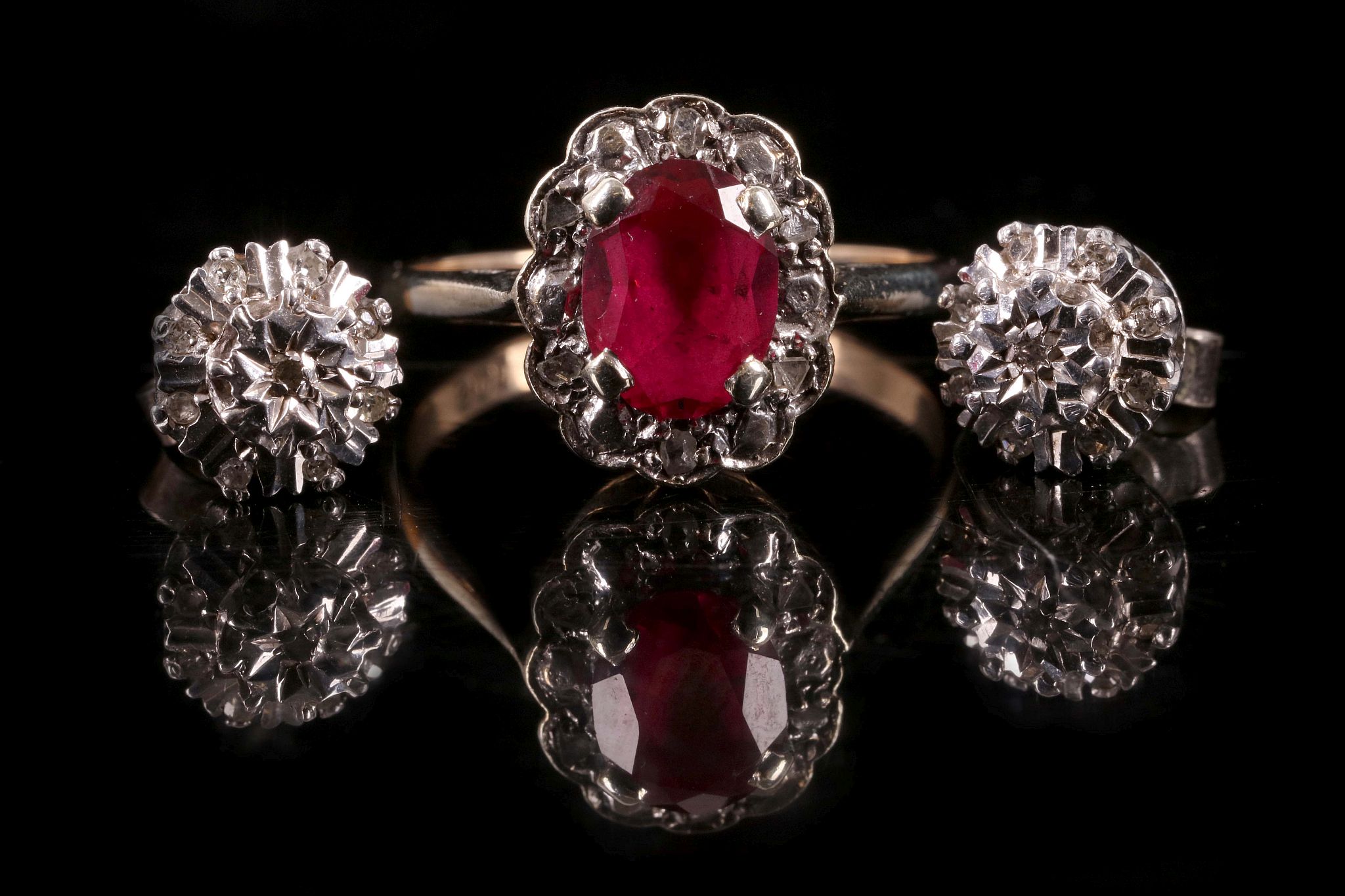 A synthetic ruby and rose cut diamond cluster ring, and a pair of illusion set diamond cluster ear
