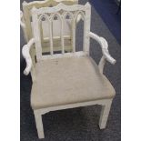 A pair of white painted Gothic design armchairs.