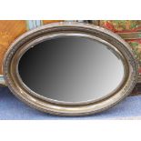 An Edwardian oval wall mirror with deep moulded frame, 92 x 69cm.