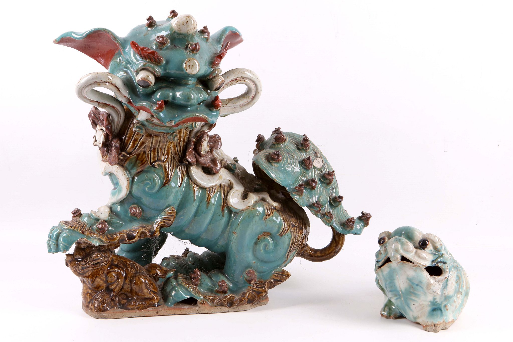 A late 19th Century Chinese glazed pottery figure of a Foo dog, finished in blue, red and brown