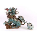 A late 19th Century Chinese glazed pottery figure of a Foo dog, finished in blue, red and brown