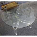 A modern oval glass topped coffee table, on lucite support, 121 x 92cm.