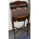 A bijou Victorian mahogany bureau with arched tambour, raised on tapered legs.