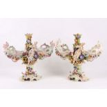 A pair of Continental porcelain candlesticks, late 19th Century, probably Thuringian, modelled