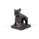 A bronze seal with a bear standing on a flat square base, the mouth open bearing a gleeful