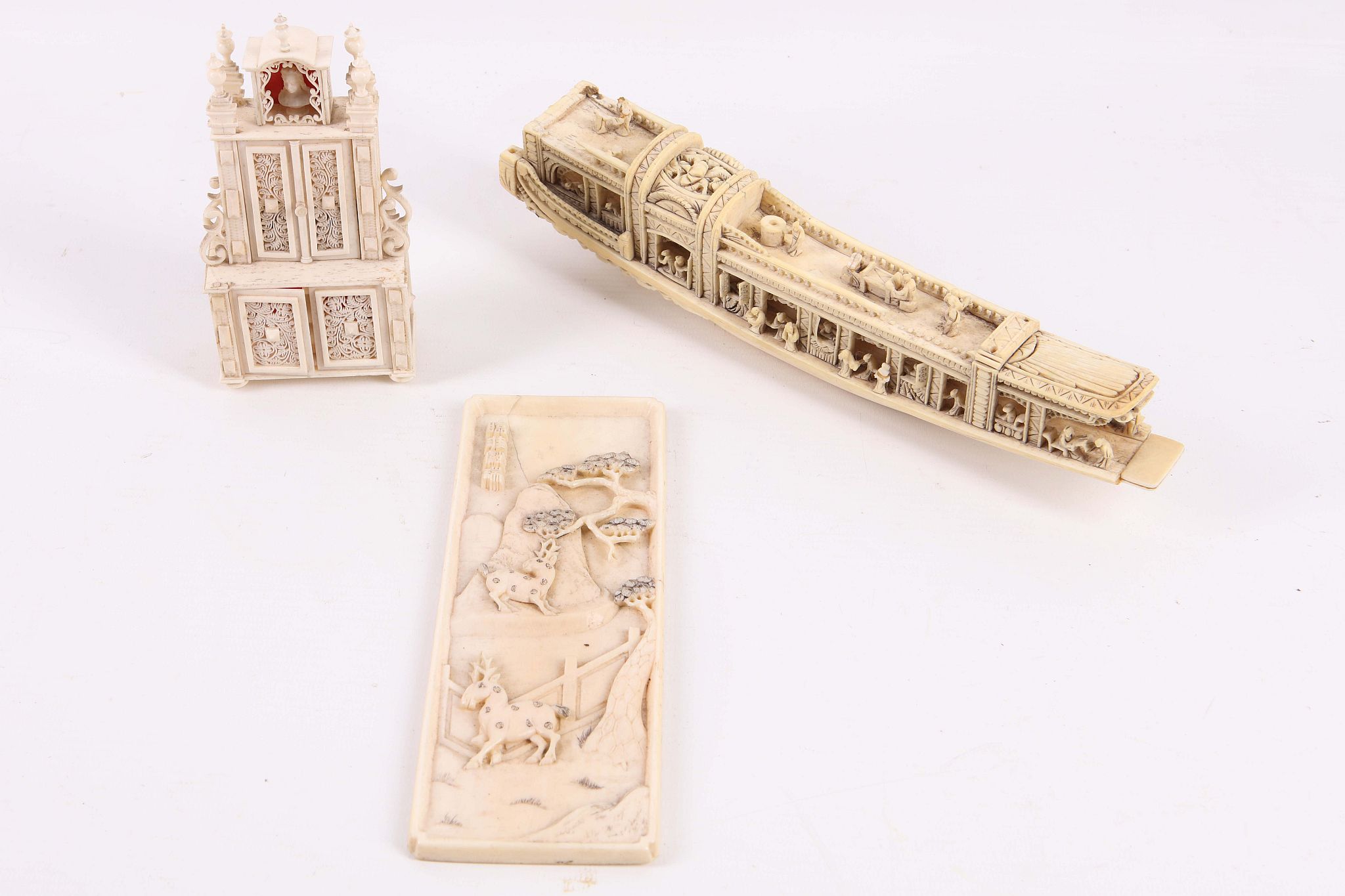 A 19th Century carved bone miniature cabinet, with turned finials and pierced doors, sold with a