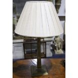 A brass table lamp, with silk shade.