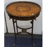 An oval occasional table with applied decoration and pierced brass gallery, raised on cast brass