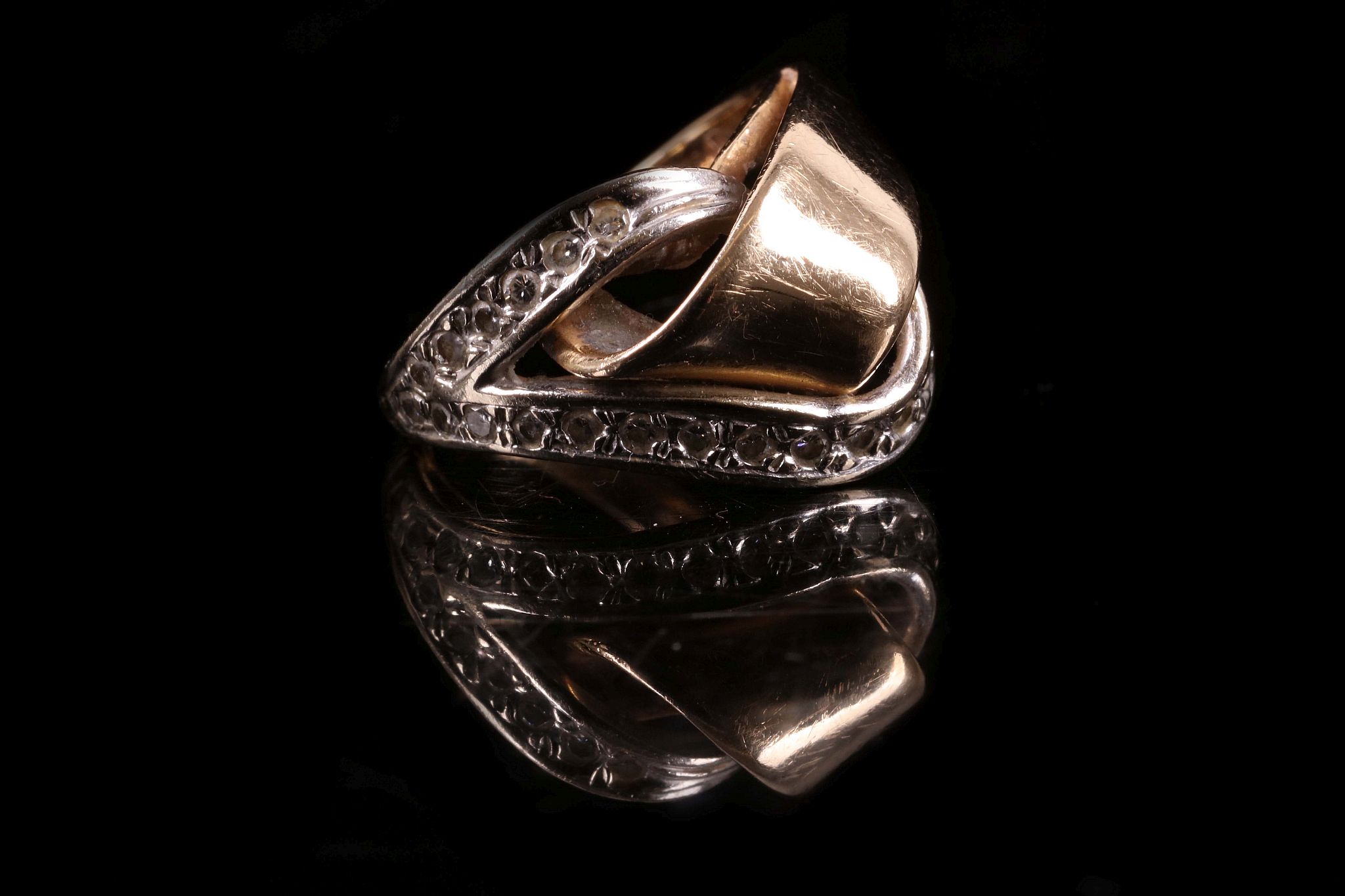 A 14ct yellow gold and diamond set entwined loop ring.