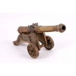 A very early 20th Century bronze model of a military cannon, having two dolphins applied to the