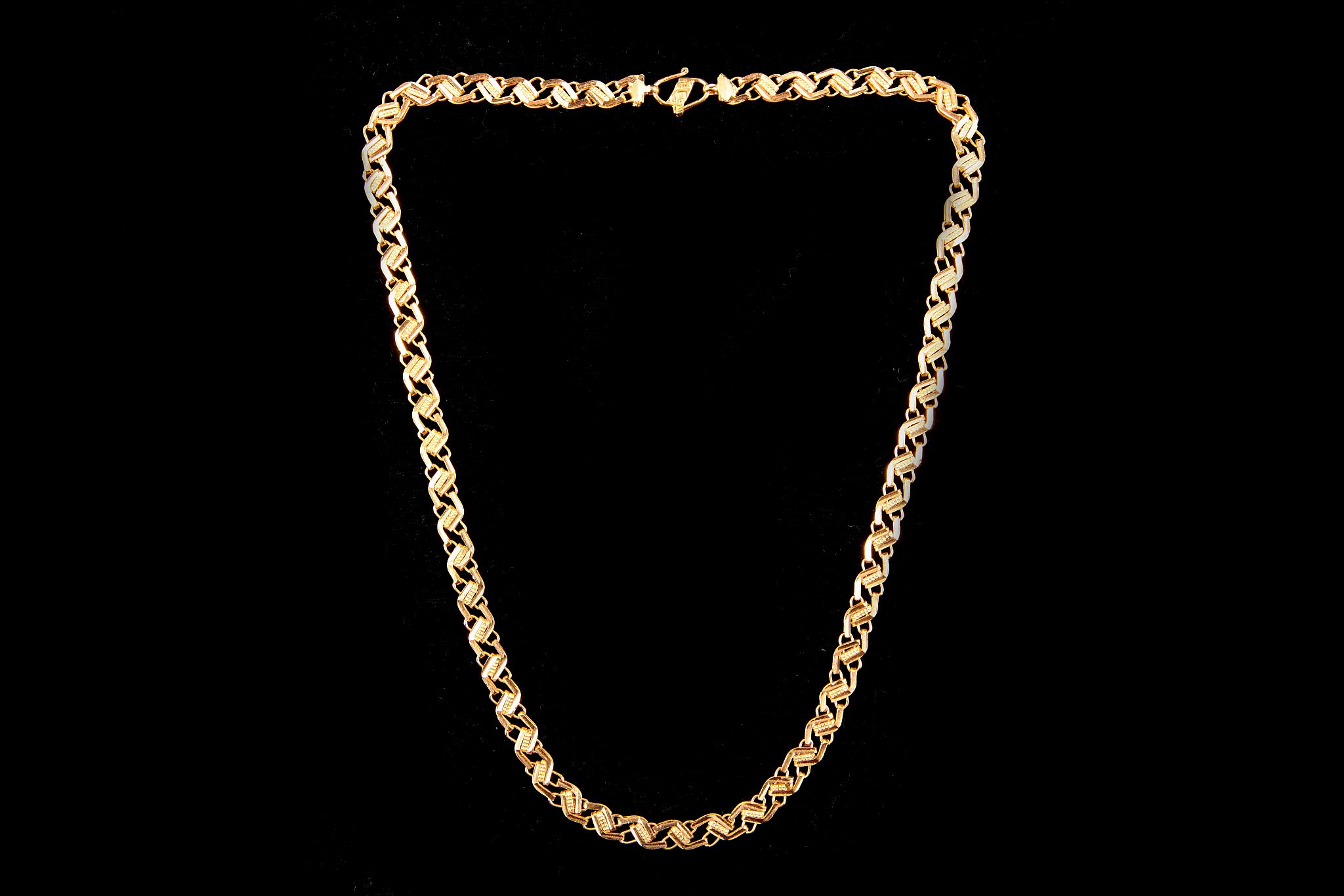 An unhallmarked yellow metal fancy zig zag necklace, 43cm long. Approx. total weight: 20g.