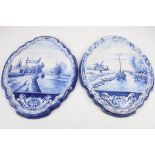 A good pair of Dutch Delft blue and white wall plaques, late 19th Century, of shield shape,