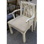 A pair of white painted Gothic design armchairs.