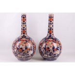 A pair of large Japanese 19th Century Imari bottle shaped bases, decorated on white background,