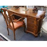 A 20th Century shaped top twin pedestal desk, with 3 frieze drawers over an arrangement of 3 drawers