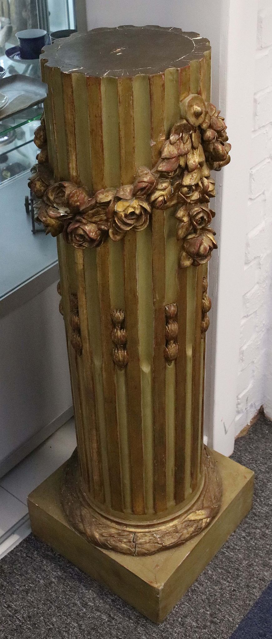 A 20th Century giltwood neo-classical column surrounded by garland of flower heads, raised on square