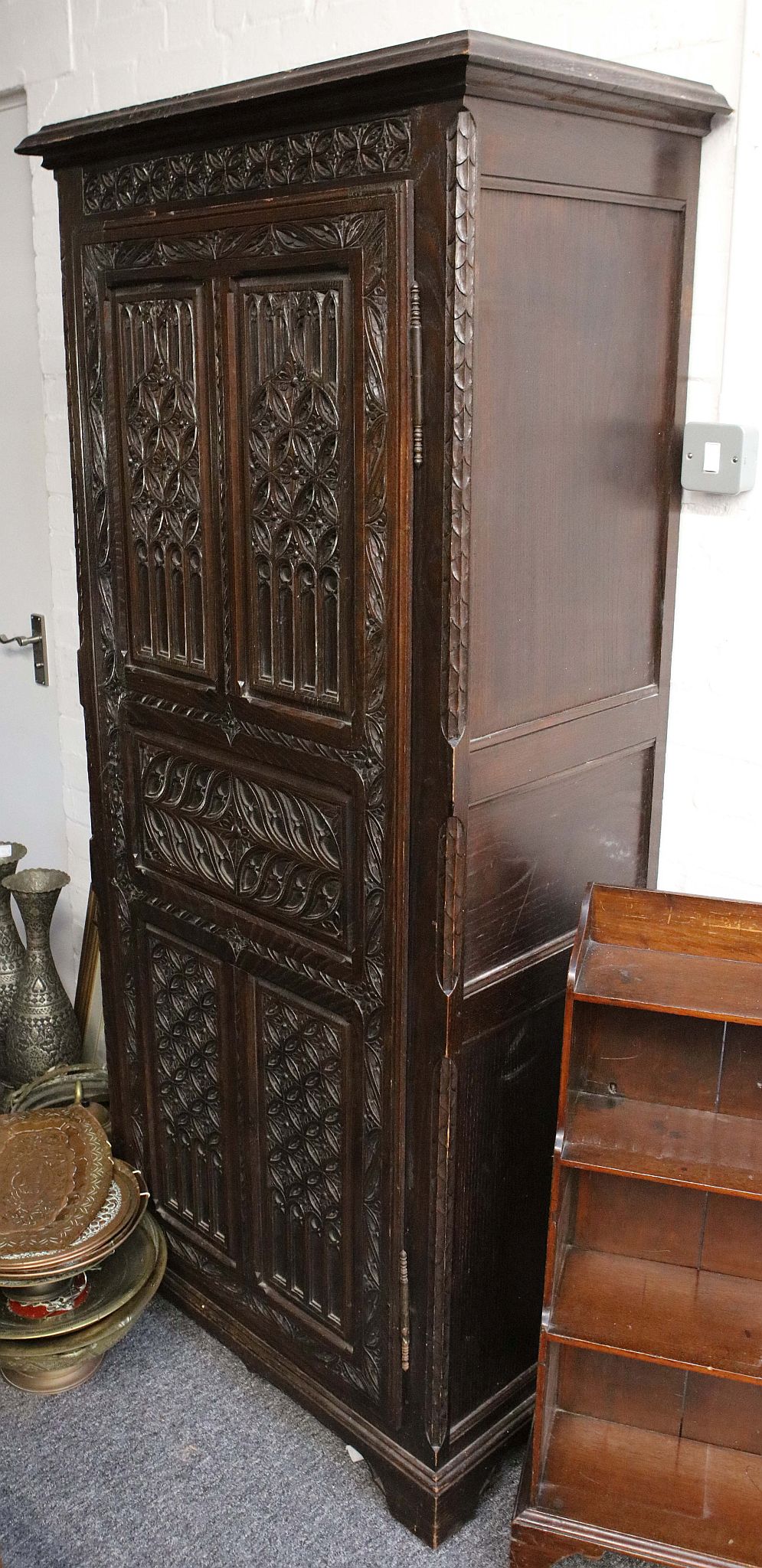 An antique oak hall cupboard,with carved single door.