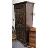 An antique oak hall cupboard,with carved single door.