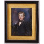 An early 19th Century portrait miniature of a young boy in landscape view, oil on ivory (