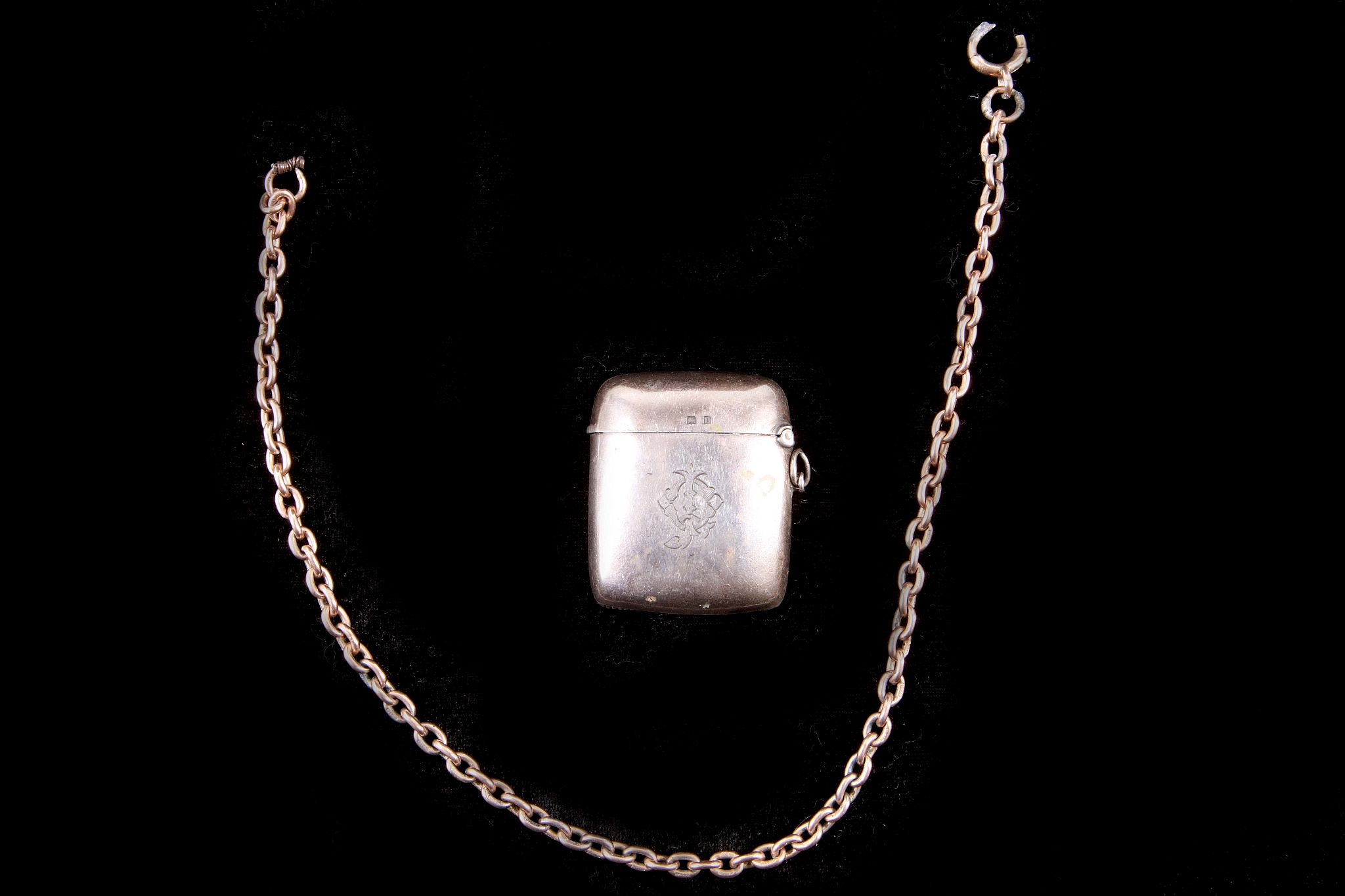 An antique 9ct yellow gold plain oval link watch chain weighing 2g, and an antique silver vesta case