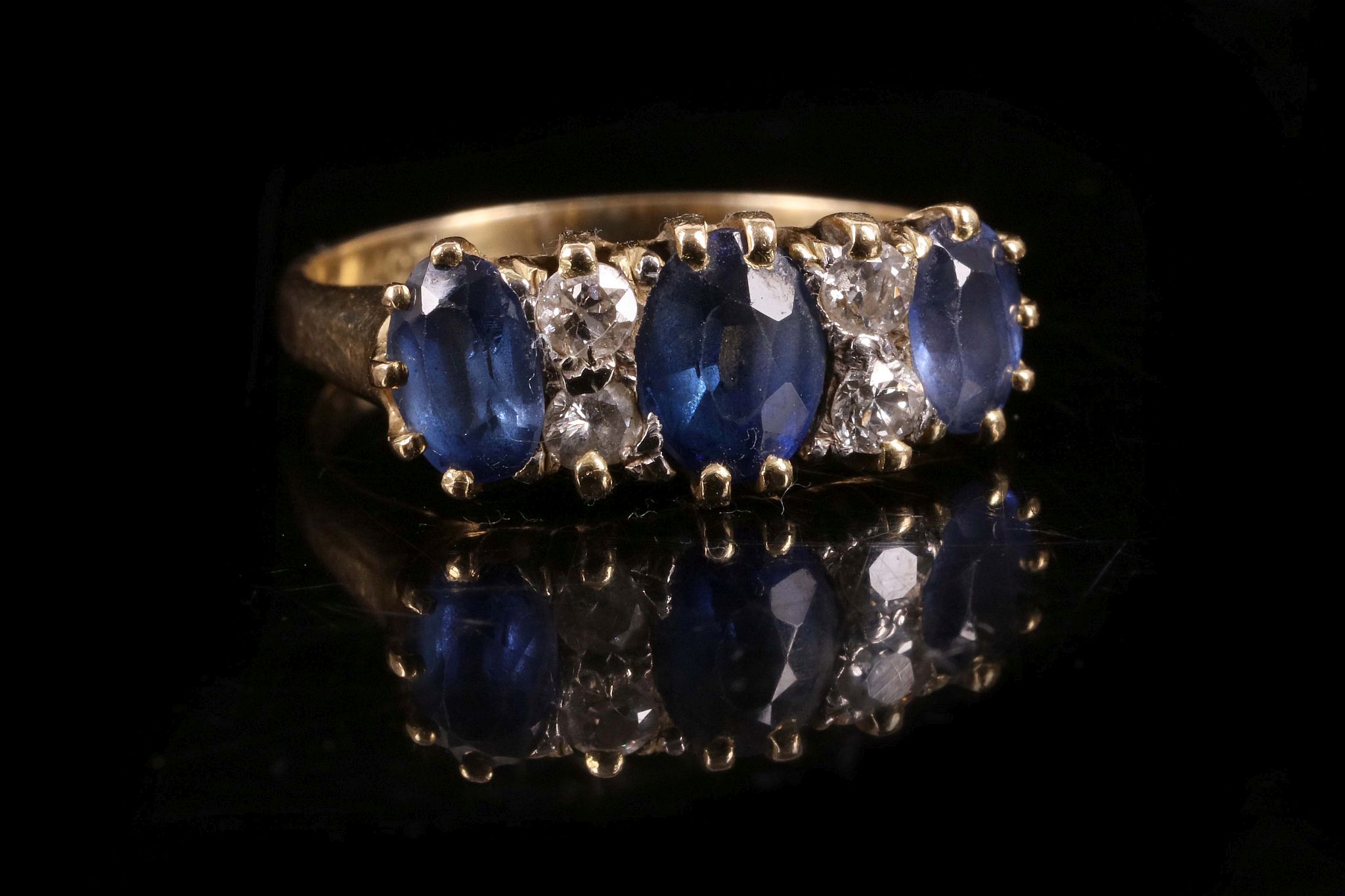 A late Victorian sapphire and diamond seven stone ring, mounted in 18ct yellow gold.