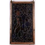 A stained glass panel of a praying saint, 69 x 39.5cm.