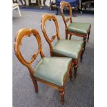 A set of six balloon back dining chairs with green leather covered drop-in seats.