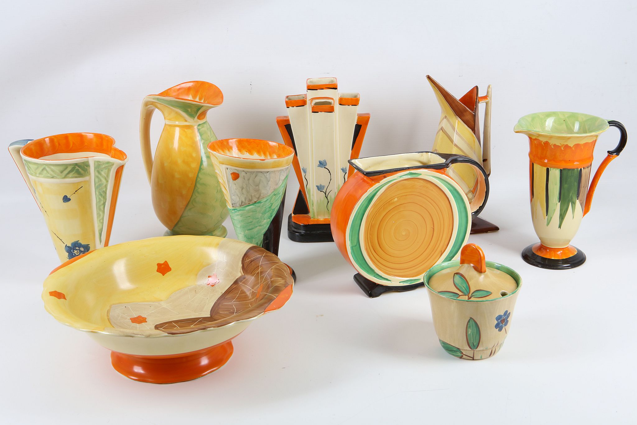 A collection of nine Art Deco period Staffordshire Myott & Son Co., pottery items, mostly jugs,