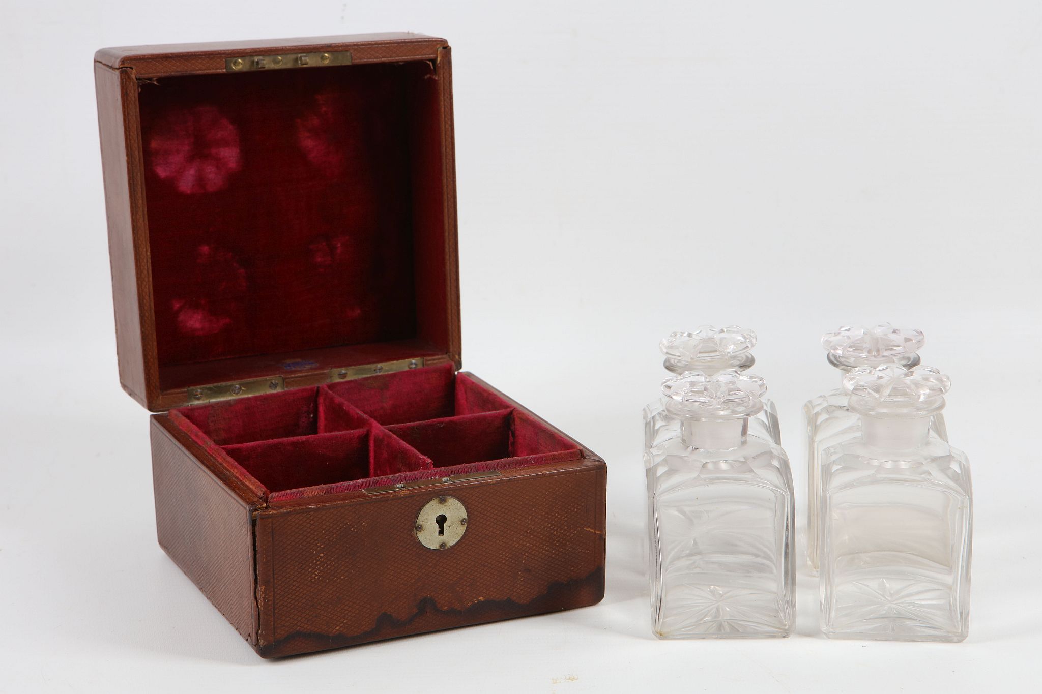 A set of four late Victorian crystal cut glass travelling scent bottles, all having star cut bases
