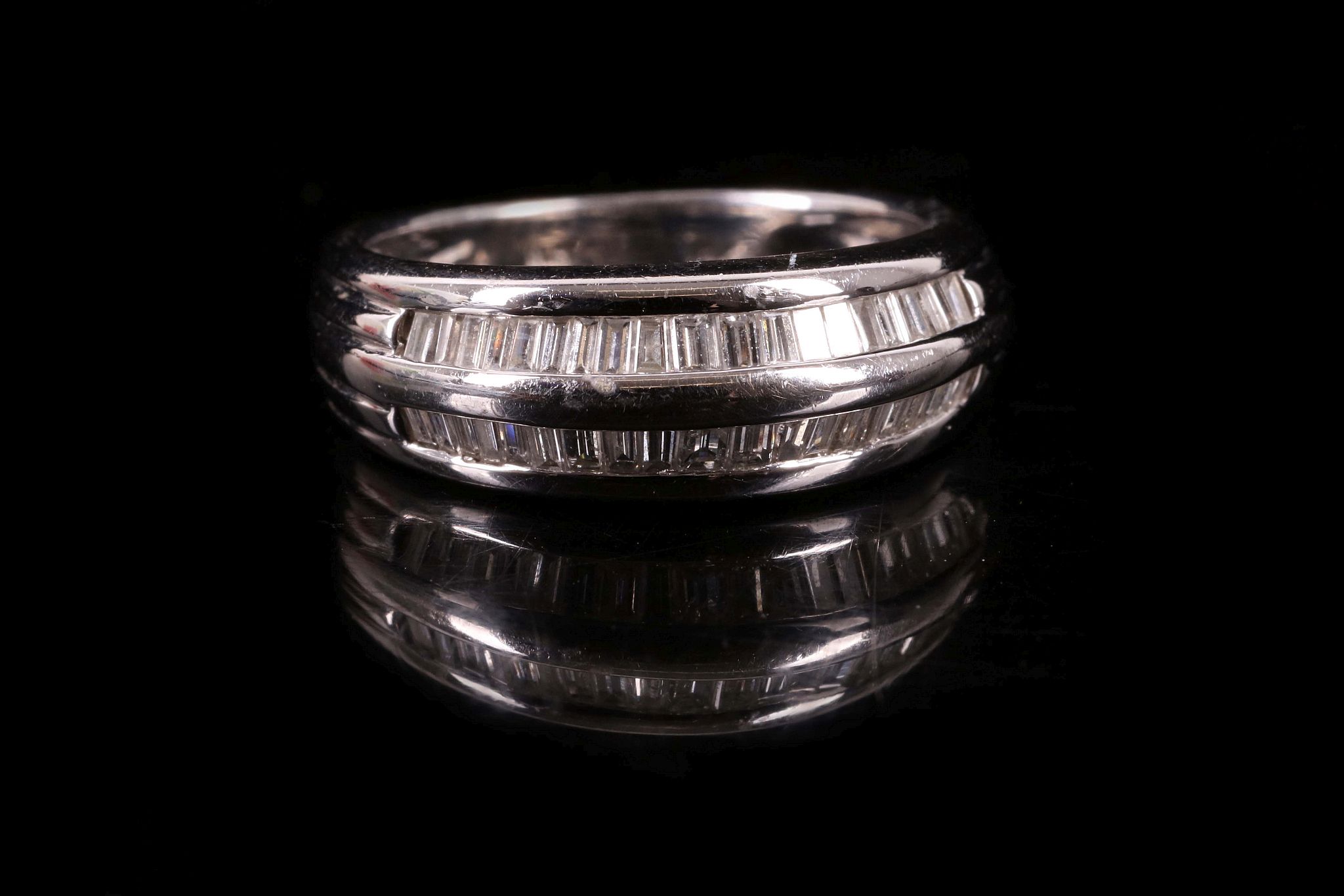 A c.1990's 14k white gold and diamond set double row half eternity ring. Size: K.