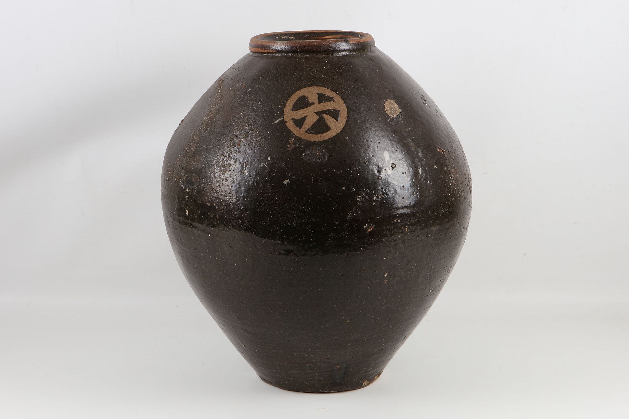 A late 19th / early 20th Century large terracotta pot in dark brown glaze.